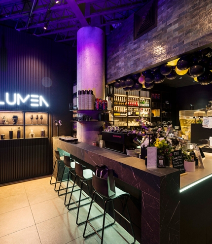 Bar with green stools inside Lumen Cafe Lounge Toowong