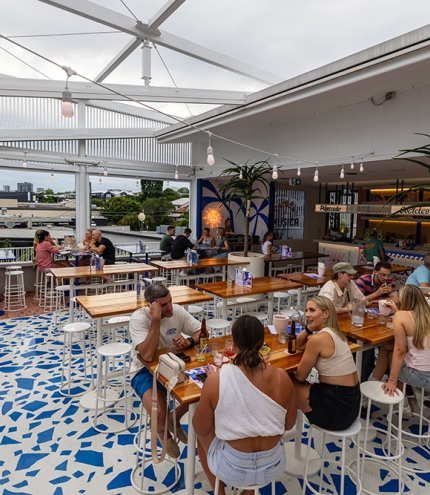 People sitting at tables outside Mexicali Bar Y Taqueria Bulimba 