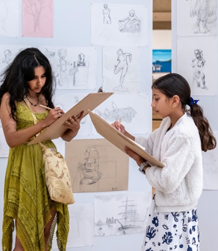 Two people drawing