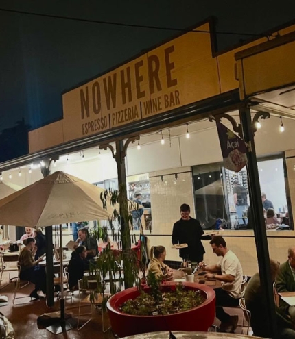 Exterior of Nowhere Espresso & Bar by night