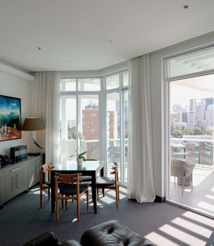 Hotel room with view, table & chair at The Point Brisbane Hotel