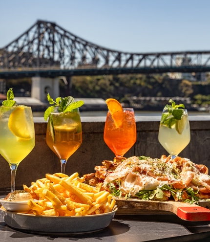 Cocktails and food in front of the Story Bridge