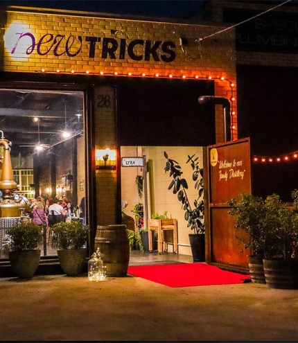 Exterior entry to New Tricks Albion by night