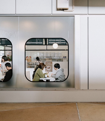Looking through train-like windows at people dining inside the Tea Station, Eight Mile Plains