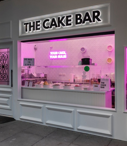 Lit up facade of The Cake Bar