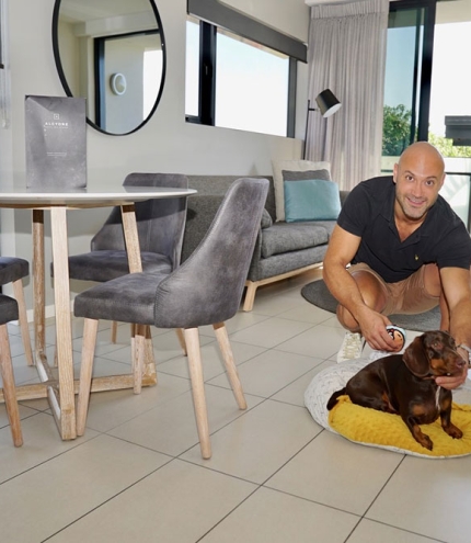 Man with dog in foyer of Alcyone Hotel