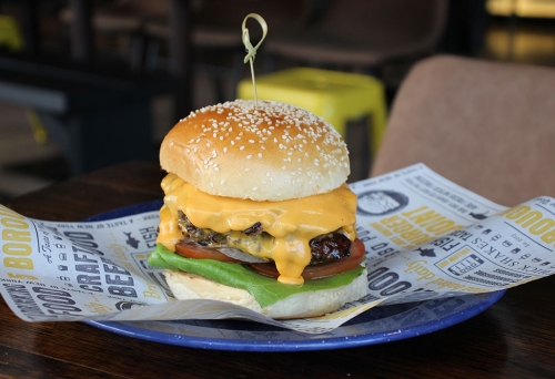 Burger on a plate at 5 Boroughs Rosalie
