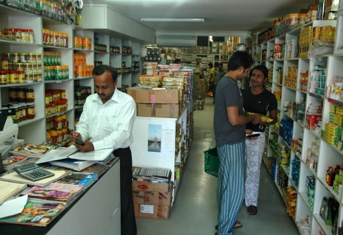 People shoping inside All India Foods supermarket.