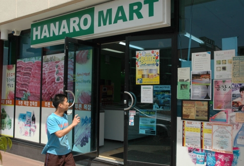 Man waliking in front of hanaro mart in sunnybank.