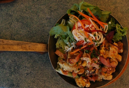 Grostl (a mishmash of pan-fried ingredients such as bacon, egg and knodel or dumplings) in a frying pan with an accompanying salad at K & K Austrian Coffee House Sinnamon Park 