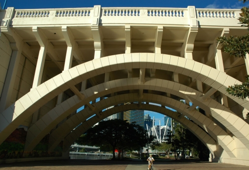 Kid cycling under Jolly Bridge 