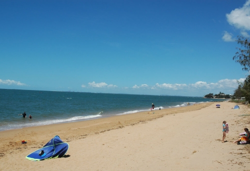 People on Margate beach swimming in summer.