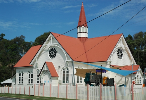 Sandgate Baptist Church building and orange rooftop on a sunny day in Sandgate.