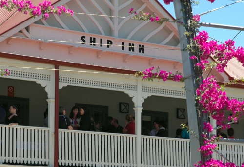 People drinking on top front veranda inside the Ship Inn  pub in Brisbane.