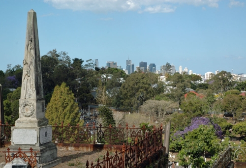 Tomb stone with city views from top of hill in Toowong Cemetery.