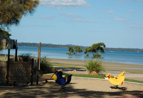 Kids playground and beach next to the sea looking out to islands on Moreton Bay.