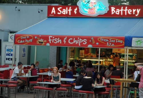 People eating fish and chips on terrace of a Salt and Battery 