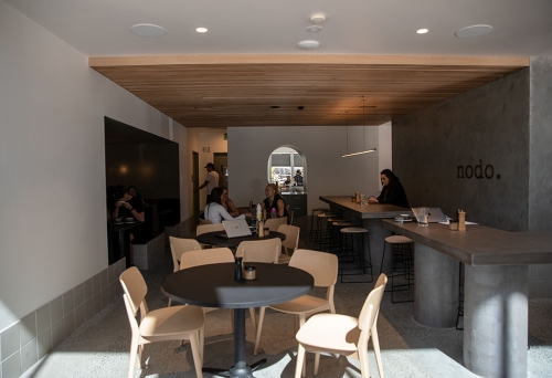 Tables and chairs inside Nodo Donuts Newstead