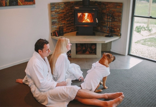 Couple with dog inside room at Alure Stanthorpe