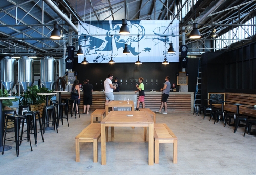 Bench seating and people standing at the bar at Ballistic Beer Co Salisbury
