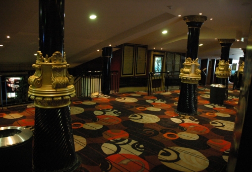 Foyer with columns and coloured carpet inside the Balmoral Cinema in Bulimba