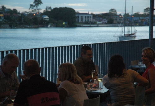 Diner sitting on Bar Alto's balcony looking over Brisbane River