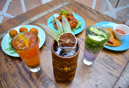 Drinks in glasses and three plates of food at Barbossa Bar & Bottleshop