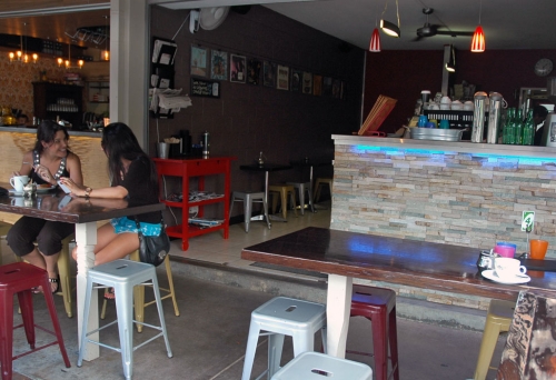 Couple sitting at table in front of bar at Buzzstop Espresso Bar in Samford