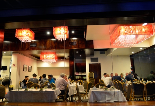 Lit up dining room from outside by night, Enjoy Inn Hamilton Harbour