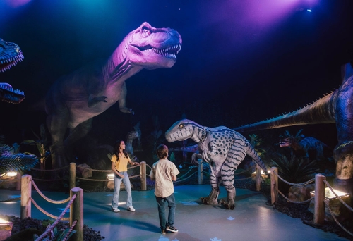 People lookign at dinosaurs