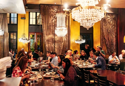 Diners at table inside of Libertine 