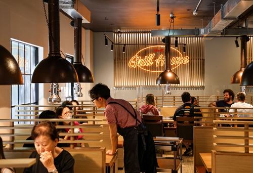 Wait staff talking with diners inside Maru Grill House Brisbane CBD