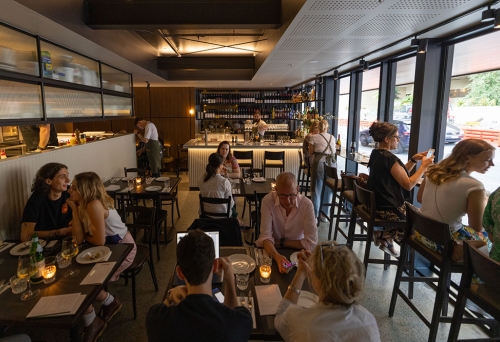 People sitting at tables inside Bar Rosa South Brisbane