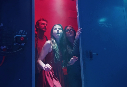 Scared people entering the doorway into Project Immersive's Area 1 Escape Rooms