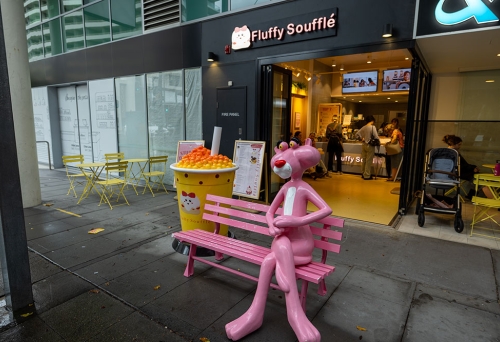 Pink Panther statue sitting on a bench outside of Fluffy Souffle South Bank