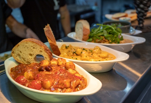 Dishes of gnocchi on table