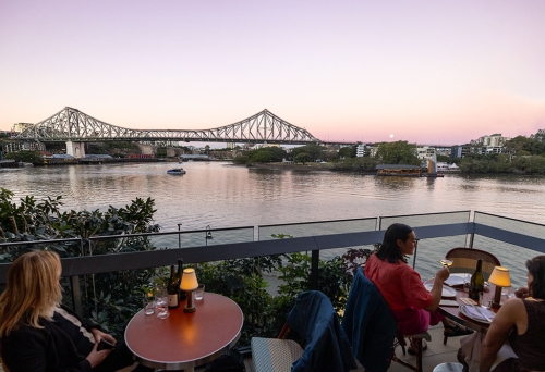 Diners sitting outside with view of Story Bridge and Brisbane River at Bar Miette Brisbane City 