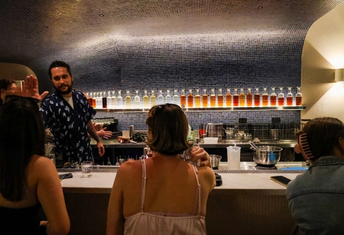 People sitting at a cocktail bar
