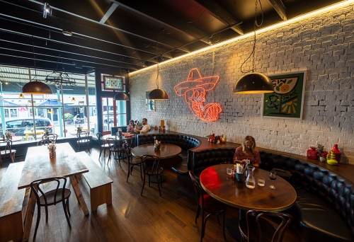 People sitting at tables inside La Carmela Petrie Terrace