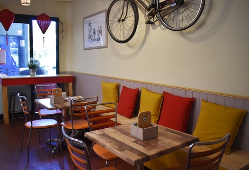 Pushbike on wall and seating inside Little Hoi An Vietnamese Restaurant
