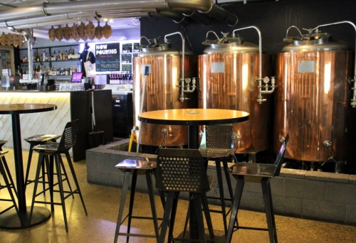 Tables and stools inside of Milton Common brewery