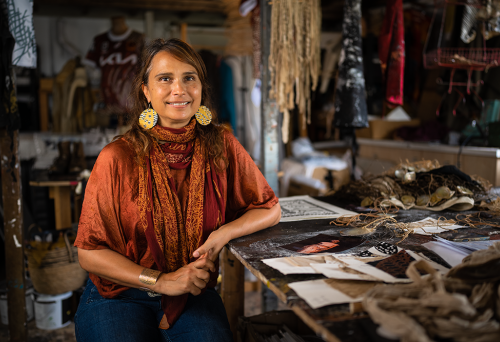 Artist Delvene Cockatoo-Collins sitting in her studio