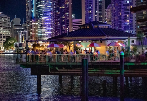 Mr Percival's bar exterior at night with Brisbane high rises in background
