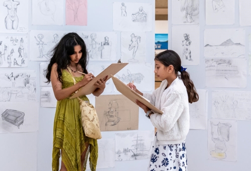 Two people drawing