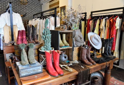 Racks of secondhand clothes for sale inside Neo-Generalist, West End, vintage store