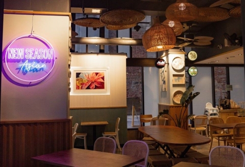 Tables and chairs inside New Season Asian, Brisbane at night
