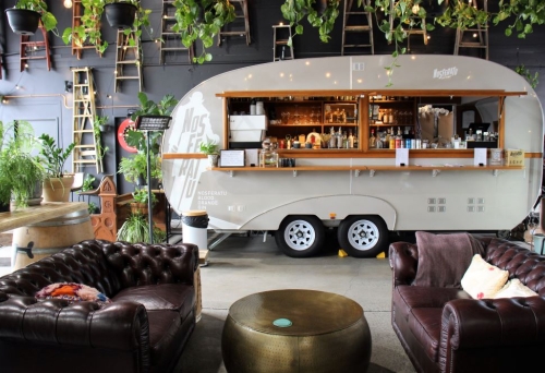 Retro caravan and two Chesterfield lounges inside Nosferatu Distillery, Bowen Hills 