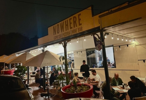 Exterior of Nowhere Espresso & Bar by night