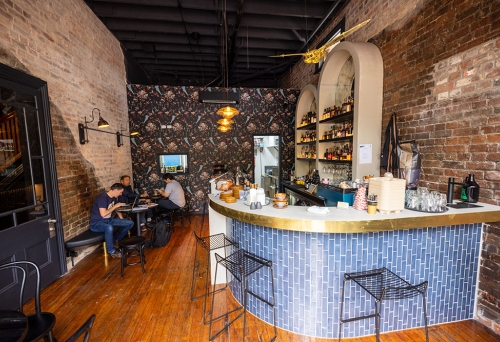 Men sitting at a table next to bar inside Fables Bar & Cafe Woolloongabba