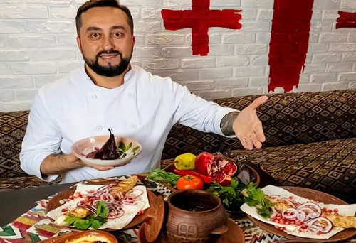 Rezo Chef with table of food